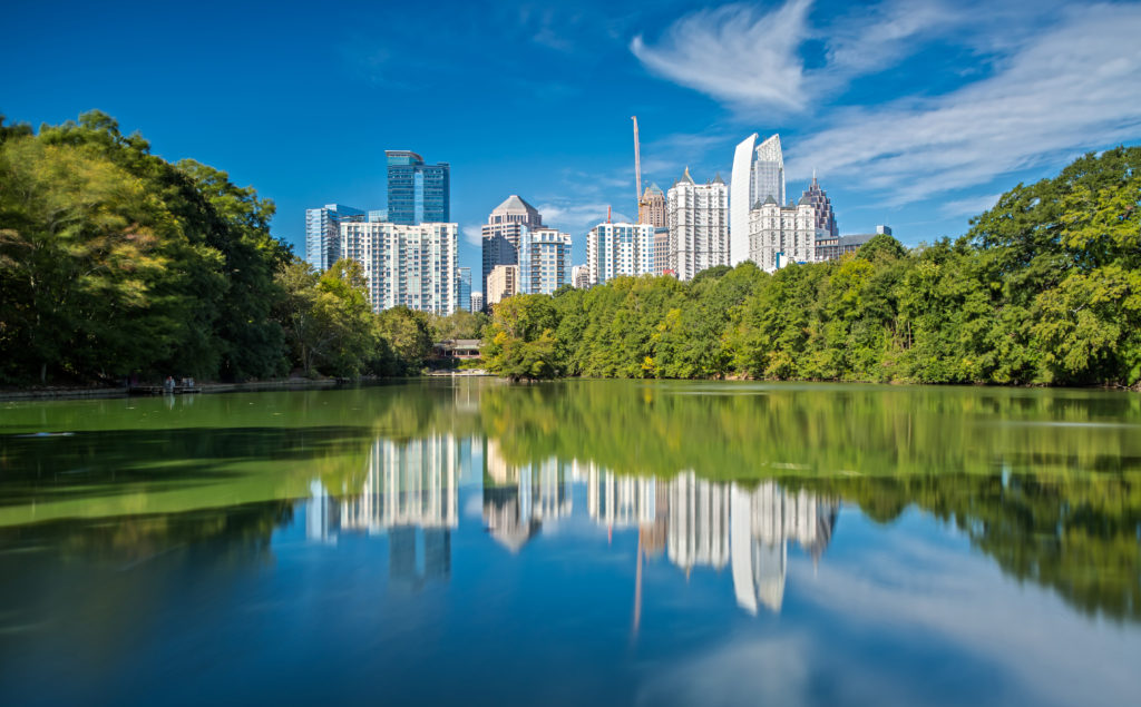 The Skyline of Downtown Atlanta is reflecting in Lake Clara in Piedmont Park